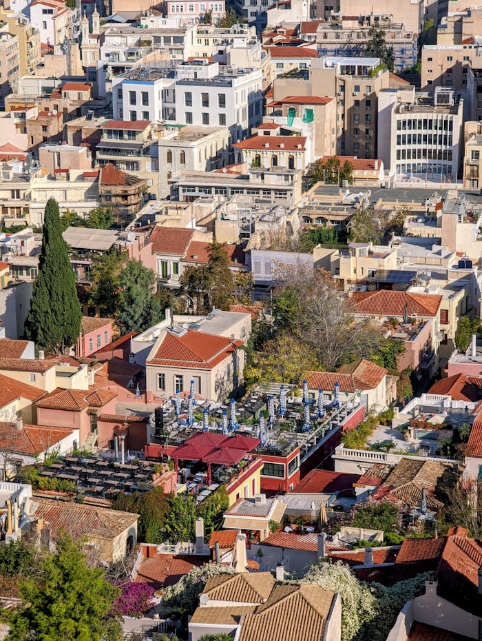 Captivating aerial view of Athens revealing urban rooftops and historical architecture.